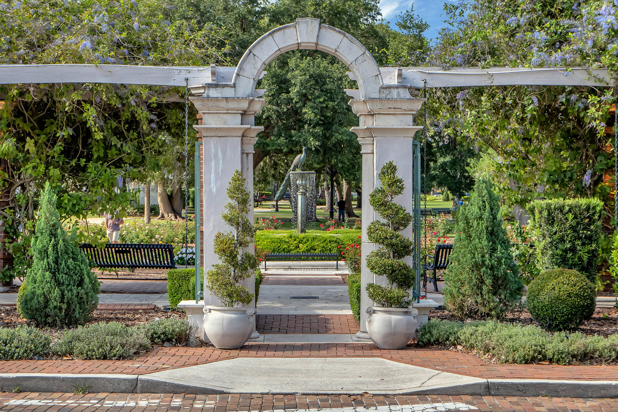 garden archway with winter park peacock at fountain